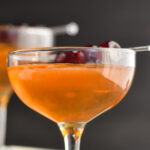 glass of Manhattan with cherry garnish