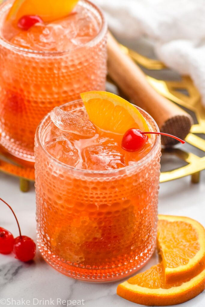 Cherry Old Fashioned garnished with orange slice and cherry