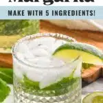 Pinterest graphic for mojito margarita. Text says "mojito margarita so easy! make with 5 ingredients! shakedrinkrepeat.com" Image shows a glass of mojito margarita with ice, mint leaves, and a lime wedge. Mint leaves and lime wedges surrounding glass.
